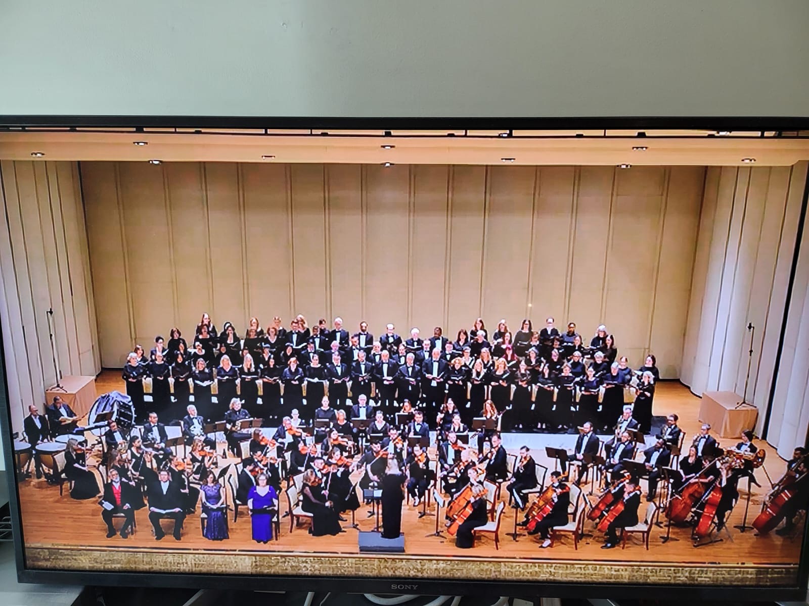 Dubai Singers and orchestra assembled on stage in concert