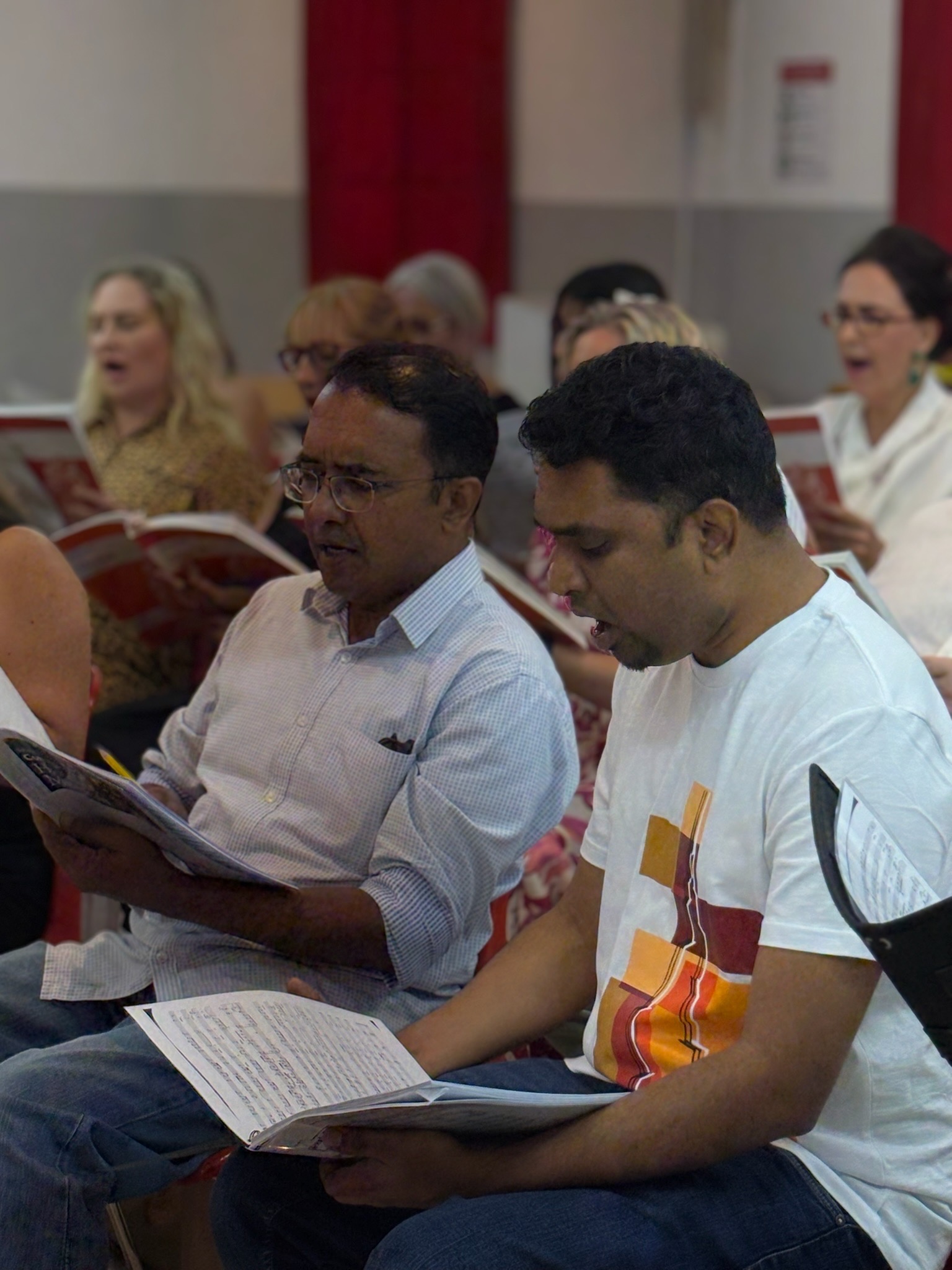 Tenors and basses singing together during rehearsal