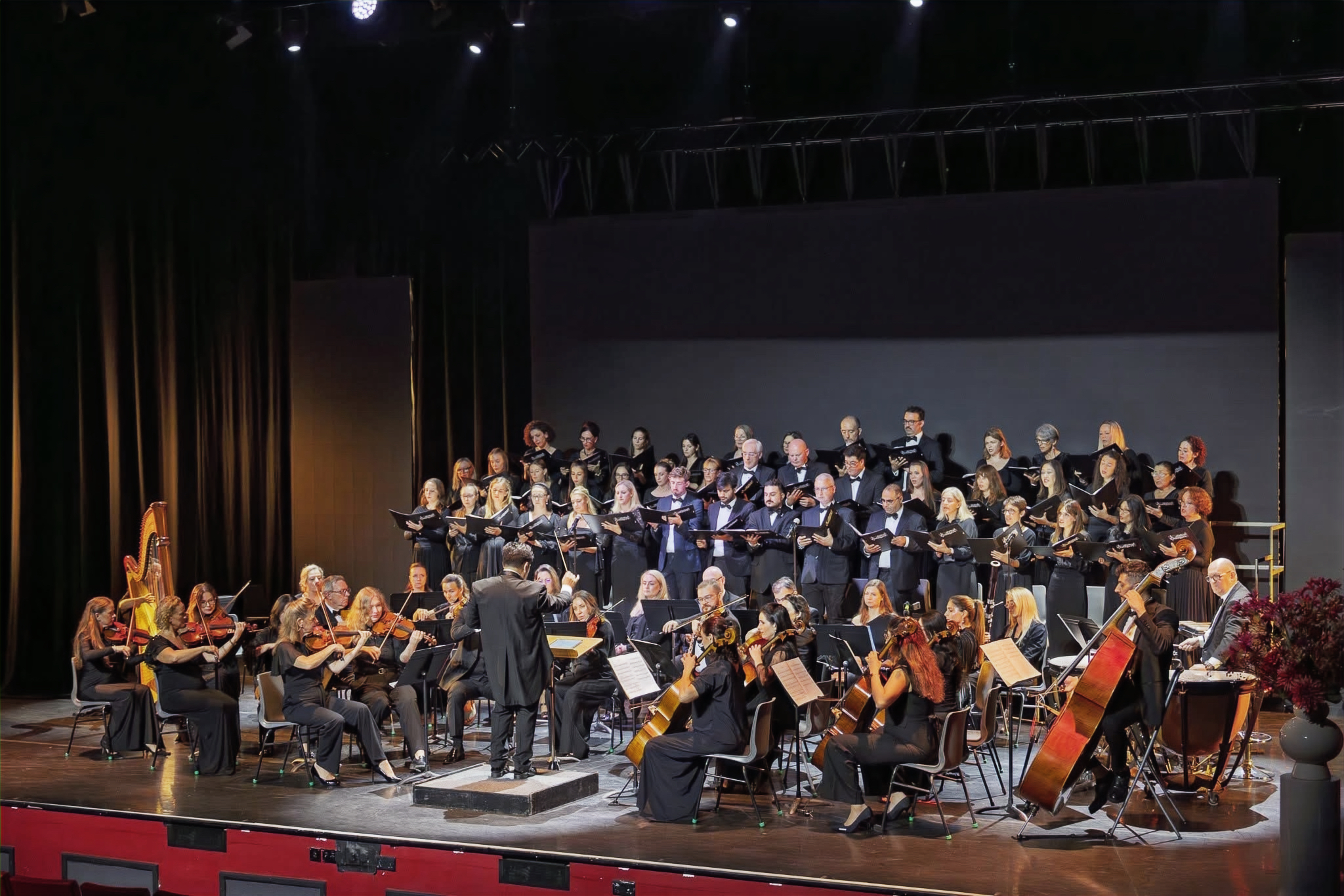 Dubai Singers and orchestra performing together on stage